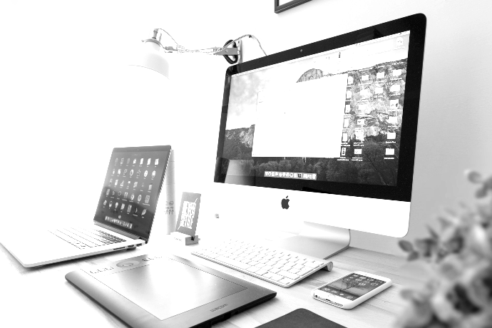 silver iMac near iPhone on brown wooden table